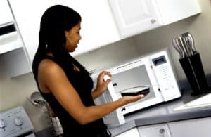 Woman heating a microwave meal