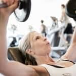 woman-lifting-free-weights-in-fitness-gym-assembly