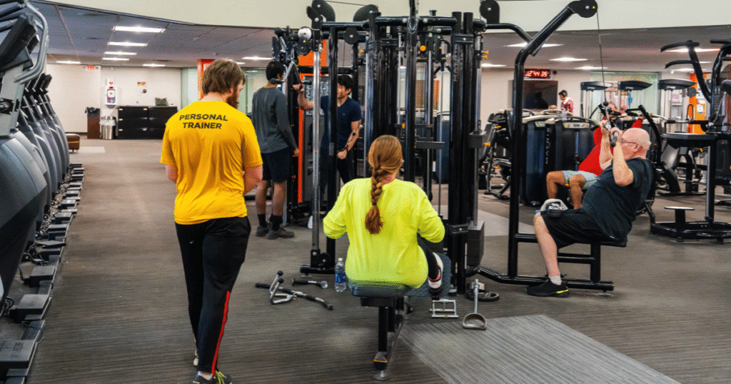 personal trainer evaluation and giving instruction to a client